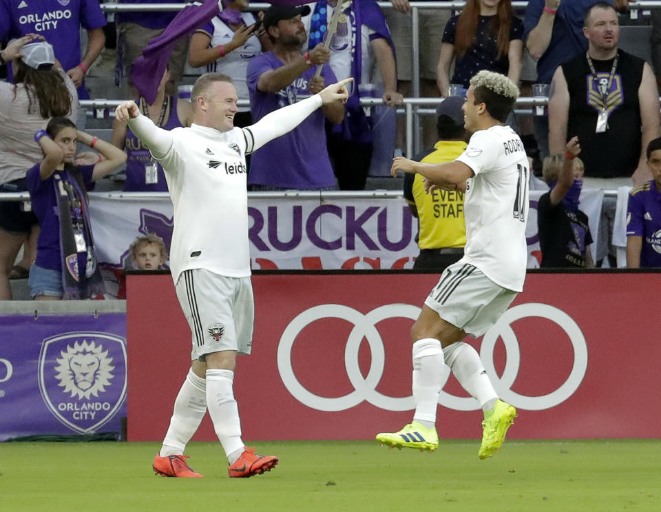 D.C. United's Wayne Rooney, left, celebrates his goal against Orlando City with teammate Lucas Rodriguez during the first half of an MLS soccer match Sunday, March 31, 2019, in Orlando, Fla. (AP Photo/John Raoux)