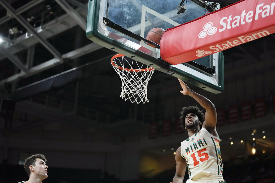 Miami forward Norchad Omier (15) scores a basket as Wake Forest forward Matthew Marsh (33) looks on during the first half of an NCAA college basketball game, Saturday, Feb. 18, 2023, Coral Gables, Fla. (AP Photo/Rebecca Blackwell)