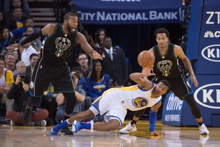 December 18, 2015; Oakland, CA, USA; Golden State Warriors guard Leandro Barbosa (19) falls while defended by Milwaukee Bucks center Greg Monroe (15) and guard Rashad Vaughn (20) during the second quarter at Oracle Arena. Mandatory Credit: Kyle Terada-USA TODAY Sports