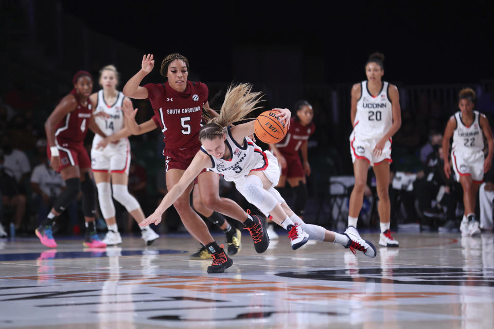 In this photo provided by Bahamas Visual Services, South Carolina forward Victaria Saxton (5) defends against UConn guard Paige Bueckers (5) during an NCAA college basketball game at Paradise Island, Bahamas, Monday, Nov. 22, 2021. (Tim Aylen/Bahamas Visual Services via AP)