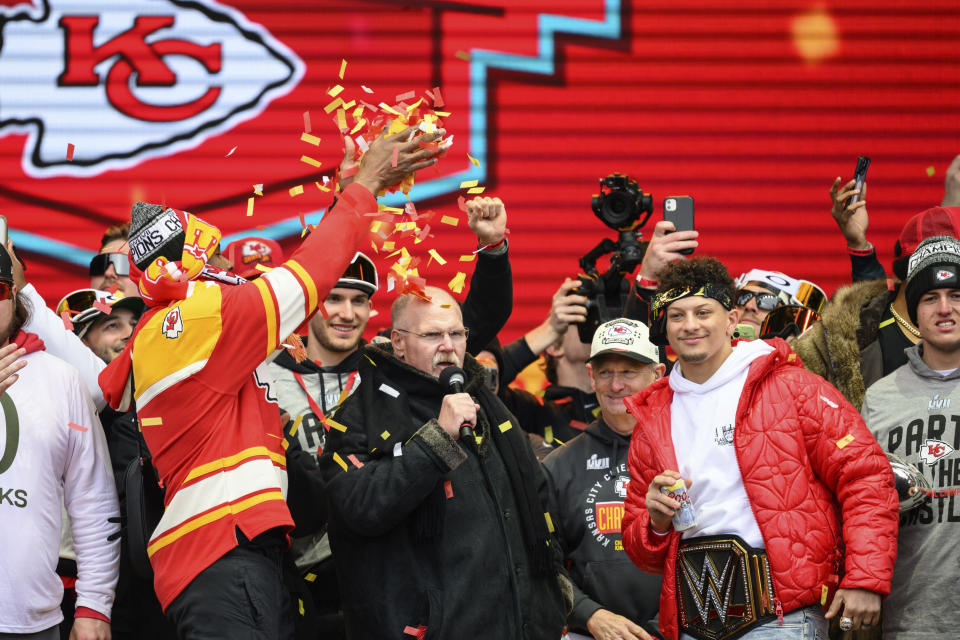 Kansas City Chiefs coach Andy Reid is showered with confetti by Carlos Dunlap as Patrick Mahomes, right, watches during the Chiefs' victory celebration and parade in Kansas City, Mo., Wednesday, Feb. 15, 2023. The Chiefs defeated the Philadelphia Eagles Sunday in the NFL Super Bowl 57 football game. (AP Photo/Reed Hoffmann)