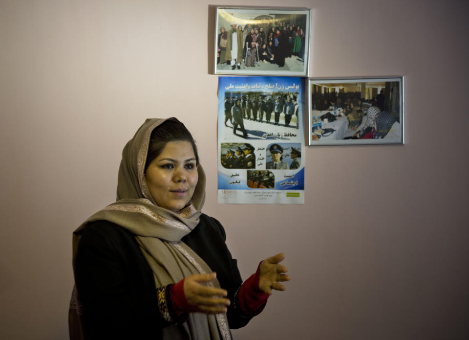 In this Wednesday, March 5, 2014 photo, prominent Afghan women’s rights activist Wazhma Frogh stands next to pictures of female Afghan police officers she trains, in her office in Kabul, Afghanistan. A gender and development specialist and human rights activist, Frogh says her experience characterizes the women’s rights movement in her country- after 12 years, billions of dollars and countless words emanating from the West commiserating with Afghan women, the successes are fragile, the changes superficial and vulnerable. (AP Photo/Anja Niedringhaus)