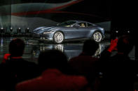 The Ferrari Roma car is unveiled in Rome, Thursday, Nov. 14, 2019. Ferrari unveils a new sports coupe aimed at enticing entry-level buyers and competing with the Porsche 911, part of a complete refresh of its model lineup by 2022. (Fabio Frustaci/ANSA via AP)