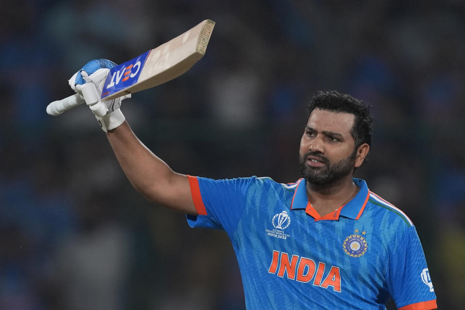 India's captain Rohit Sharma celebrates his century during the ICC Men's Cricket World Cup match between Afghanistan and India in New Delhi, India, Wednesday, Oct. 11, 2023. (AP Photo/Manish Swarup)