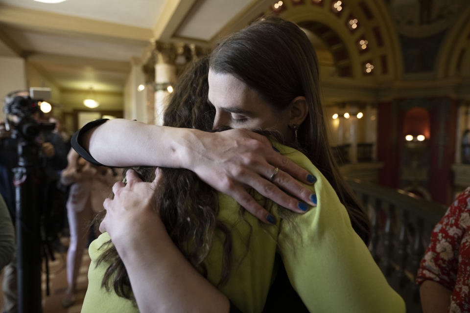 Rep. Zooey Zephyr hugs a supporter at the Montana State Capitol in Helena, Mont., on Wednesday, April 26, 2023. Republicans in Montana's House of Representatives voted to ban Zephyr from the House floor for the rest of the 2023 session on Wednesday in retaliation for her rebuking colleagues – and then participating in protests – after they voted to ban gender-affirming care for children. (AP Photo/Tommy Martino)