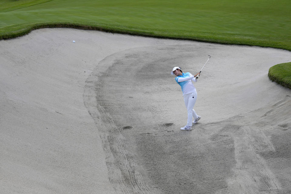 Mone Inami, of Japan, hits from the ninth green bunker during a practice round prior to the women's golf event at the 2020 Summer Olympics, Monday, Aug. 2, 2021, at the Kasumigaseki Country Club in Kawagoe, Japan, (AP Photo/Andy Wong)