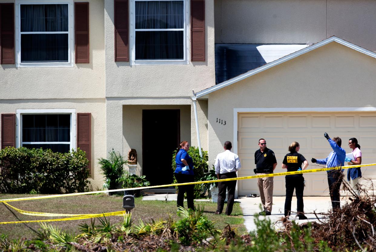 Members of the Lee County Sheriff's Office investigate the scene of a home invasion involving a death on Plumosa Ave. in Lehigh Acres on Monday 3/16/2015. Hemchand Bhagwandin, 68 was killed.