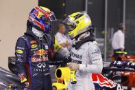 Red Bull Formula One driver Mark Webber of Australia (L) is congraluted by Mercedes Formula One driver Nico Rosberg of Germany after the qualifying session of the Abu Dhabi F1 Grand Prix at the Yas Marina circuit on Yas Island, November 2, 2013. Webber put Red Bull on pole position for the floodlit Abu Dhabi Formula One Grand Prix on Saturday in a front row sweep with quadruple world champion team mate Sebastian Vettel. REUTERS/Caren Firouz (UNITED ARAB EMIRATES - Tags: SPORT MOTORSPORT F1)