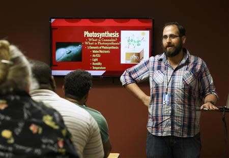 Students at the Medical Marijuana Tampa campus listen to professor of cannabis Carlos Hermida (R) in Tampa, Florida May 6, 2014. REUTERS/Scott Audette