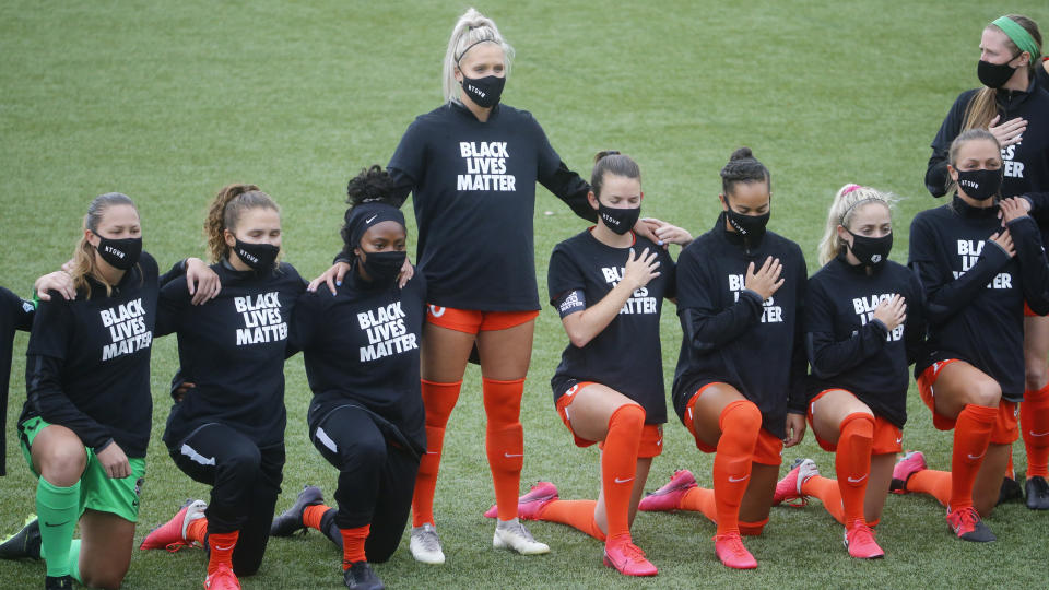 Players for the Houston Dash take a knee for the national anthem prior to their game against the Utah Royals FC during NWSL Challenge Cup at Zions Bank Stadium Tuesday, June 30, 2020, in Herriman, Utah. (AP Photo/Rick Bowmer)