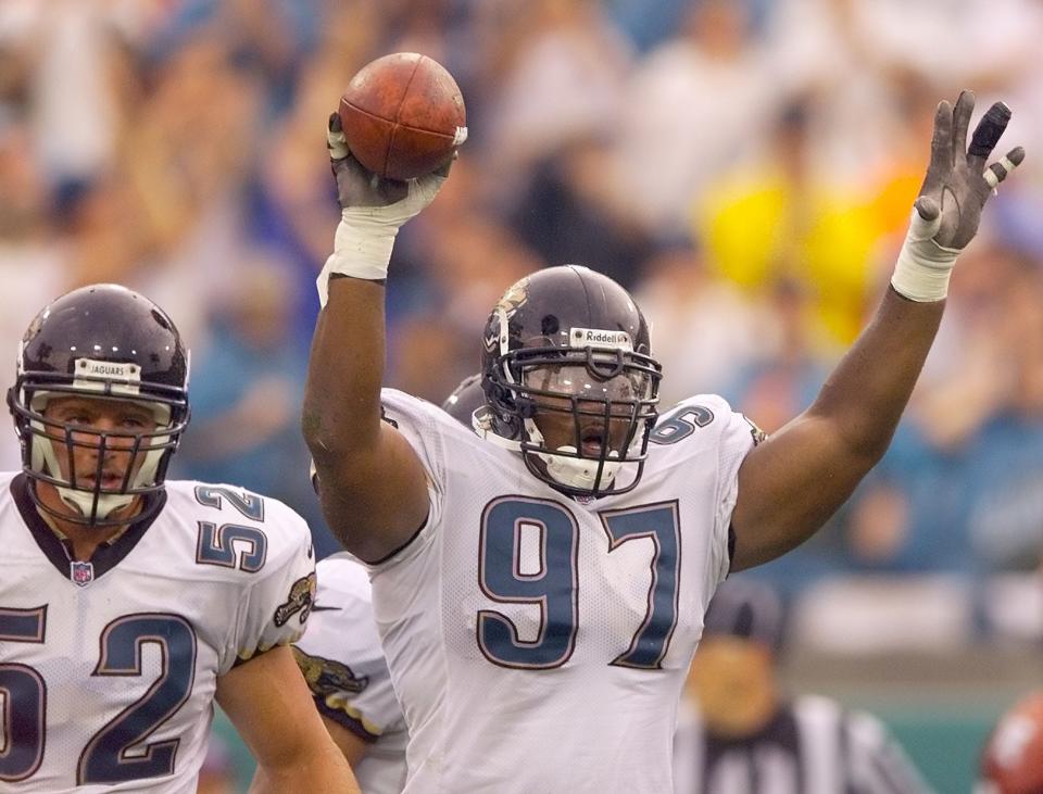 Jacksonville Jaguars defensive lineman Renaldo Wynn holds up the recovered fumble at the end of the second quarter to end a San Francisco 49ers drive in an NFL football game on September 12, 1999. [Rick Wilson/Florida Times-Union]