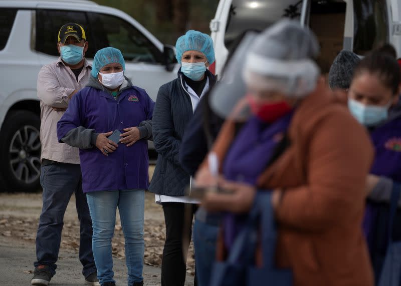 Farmworkers line up to receive vaccinations during the outbreak of the coronavirus disease (COVID-19) in Mecca, California