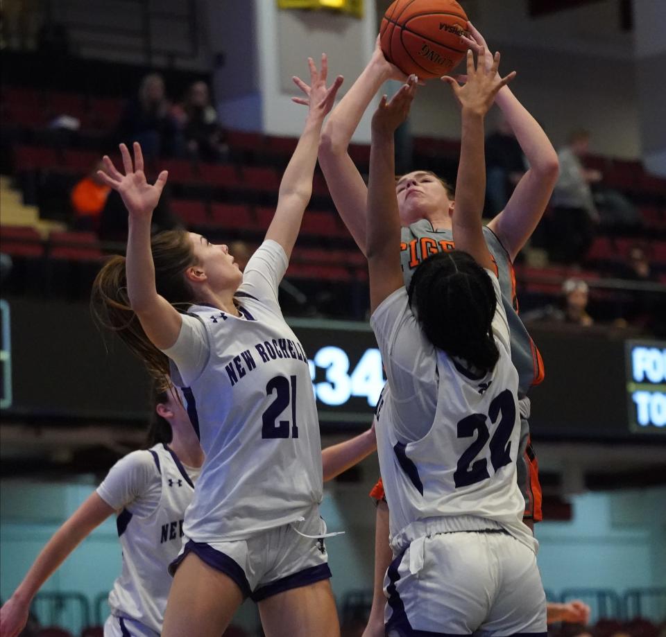 Mamaroneck's Addison Dorfman (15) puts a shot over New Rochelle's Grace Ziogas (21) and Skye Cameron-Pressley (22) in the Class AAA girls basketball semifinals at the Westchester County Center in White Plains on Wednesday, Feb. 28, 2024.