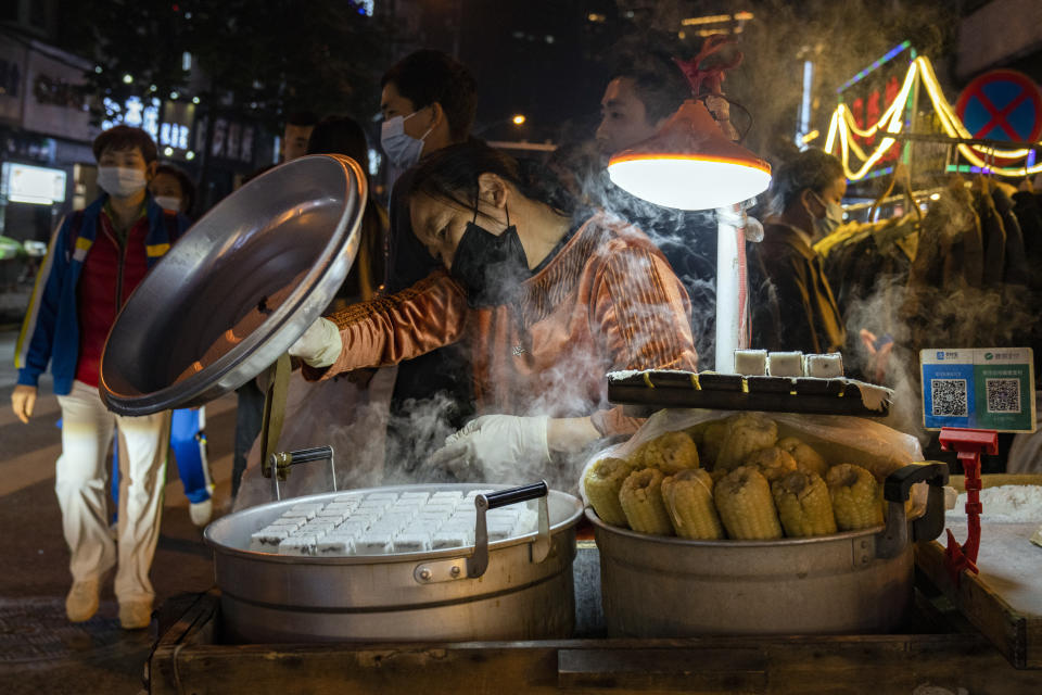 A street vendor prepares steamed delicacies in Wuhan on Sunday, Oct. 18, 2020. (AP Photo/Ng Han Guan)