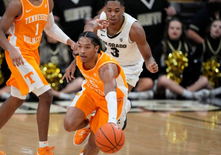 Tennessee guard Zakai Zeigler, front, picks up a loose ball as Colorado guard Keeshawn Barthelemy pursues in the first half of an NCAA college basketball game Saturday, Dec. 4, 2021, in Boulder, Colo. (AP Photo/David Zalubowski)