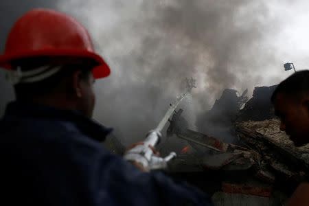 Firefighters extinguish a fire at a garment packaging factory outside Dhaka, Bangladesh, September 10, 2016. REUTERS/Mohammad Ponir Hossain