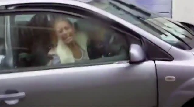 The woman continued to shout abuse as she got back into her car. Image: YouTube