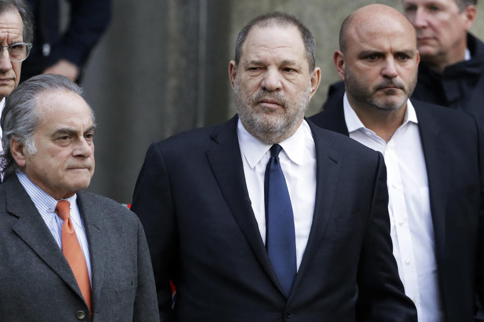FILE - In this Thursday, Dec. 20, 2018, file photo, Harvey Weinstein, center, leaves New York Supreme Court with his attorney Benjamin Brafman, left, in New York. Brafman says Weinstein’s sexual assault trial in New York is scheduled for May 6, 2019, but court officials say that’s tentative and unofficial. (AP Photo/Mark Lennihan, File)
