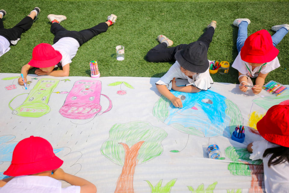 Children draw paintings of environmental protection on a canvas at a kindergarten ahead of World Environment Day on June 2, 2020 in Nantong, Jiangsu Province of China. (Photo by Xu Hui/VCG via Getty Images)