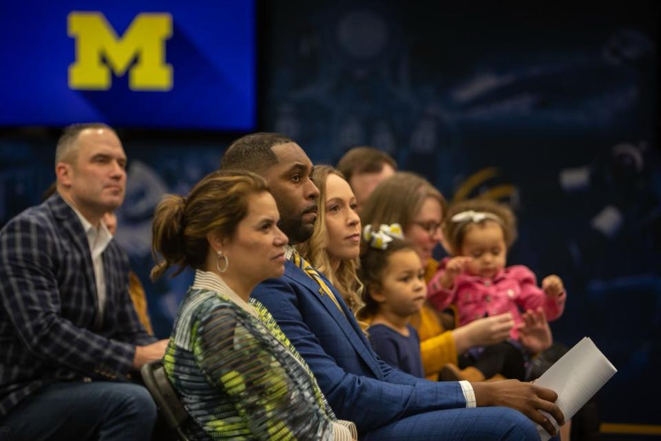Sherrone Moore, Michigan’s new head coach, sits next to friends and family during a press conference inside the Junge Family Champions Center in Ann Arbor on Saturday, Jan. 27, 2024.