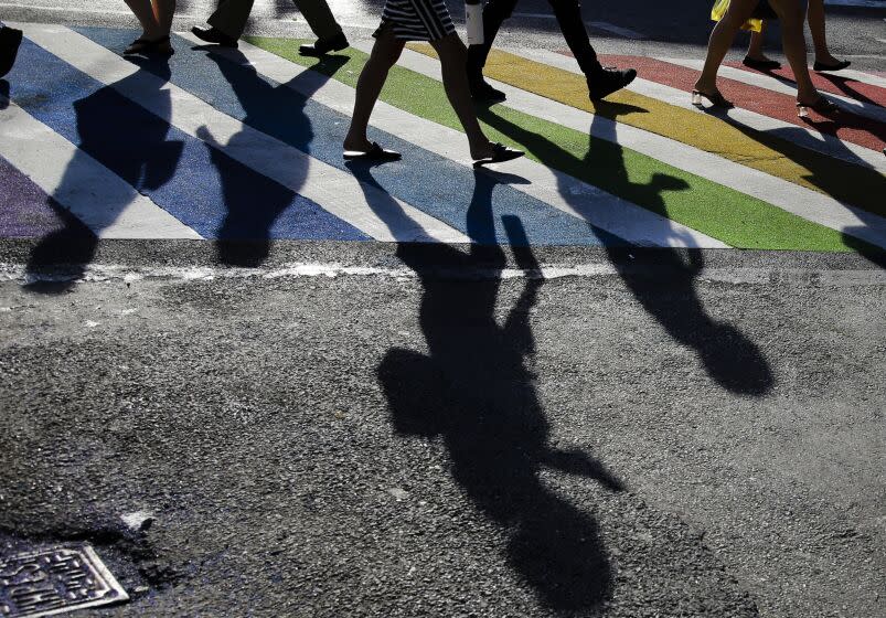 FILE - Pedestrians cross the intersection of Christopher Street and Seventh Avenue near the Stonewall Inn on June 27, 2019, in New York. The Human Rights Campaign declared a state of emergency for LGBTQ+ people in the U.S. on Tuesday, June 6, 2023, and a released "a guidebook for action" summarizing what it calls discriminatory laws in each state, along with "know your rights" information and health and safety resources. (AP Photo/Frank Franklin II, File)