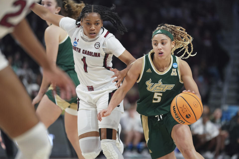 South Florida guard Elena Tsineke (5) dribbles the ball against South Carolina guard Zia Cooke (1) during the first half in a second-round college basketball game in the NCAA Tournament, Sunday, March 19, 2023, in Columbia, S.C. (AP Photo/Sean Rayford)