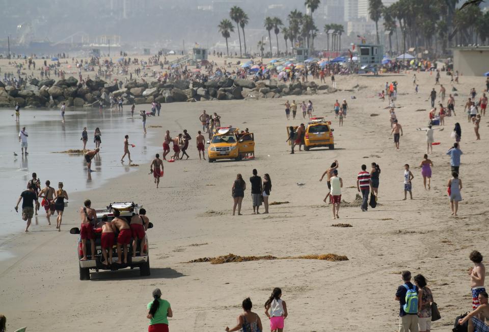 Lifeguards bring ashore the victim of a lightning strike in Venice, California July 27, 2014. (REUTERS/Jonathan Alcorn)