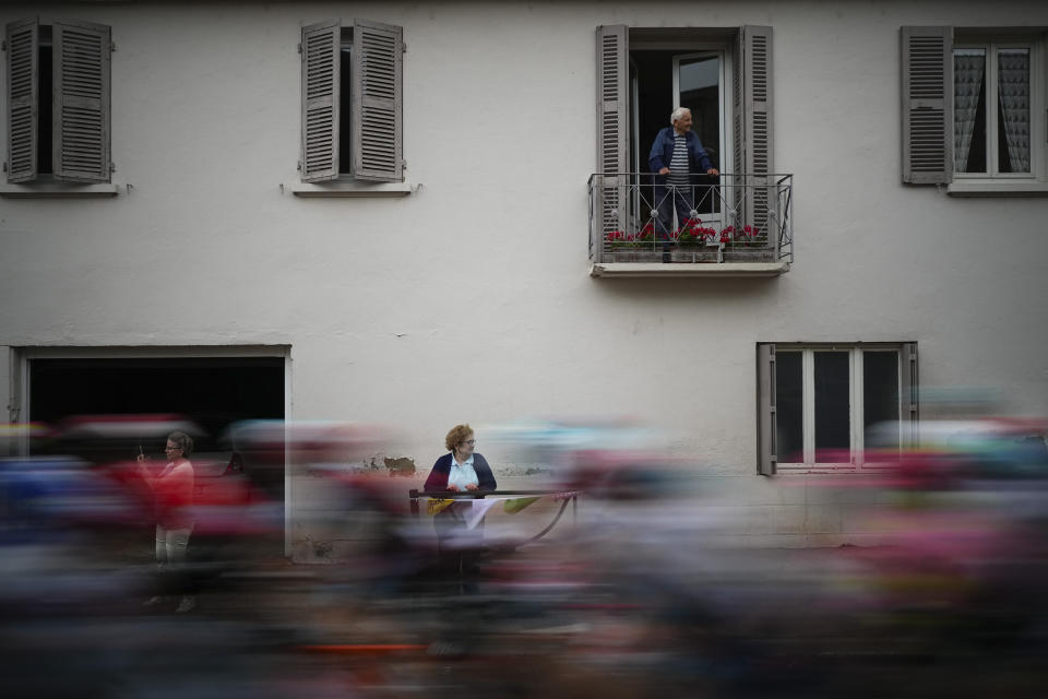 Spectators watch the pack speed by during the sixth stage of the Tour de France cycling race over 163.5 kilometers (101.6 miles) with start in Macon and finish in Dijon, France, Thursday, July 4, 2024. (AP Photo/Daniel Cole)