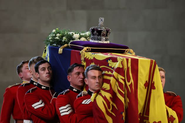 Pallbearers from The Queen's Company, 1st Battalion Grenadier Guards places the coffin of Britain's Queen Elizabeth II on a Catafalque inside Westminster Hall. (Photo: ALKIS KONSTANTINIDIS via Getty Images)