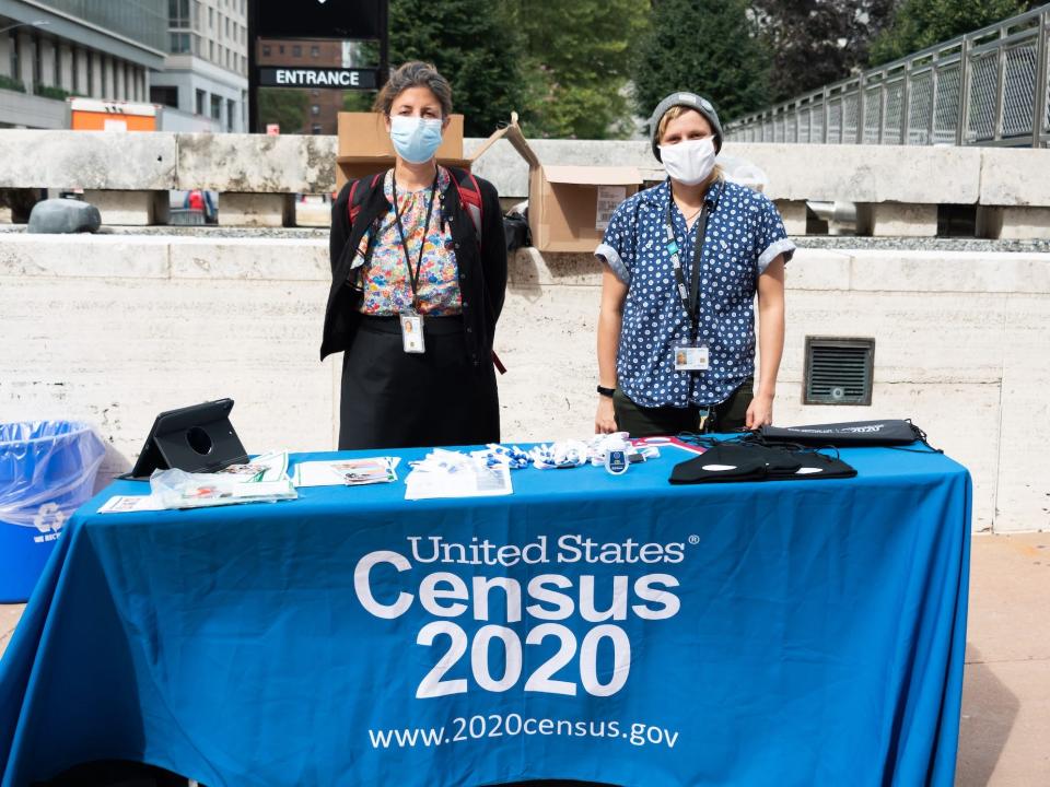 Census workers near a table in New York City.