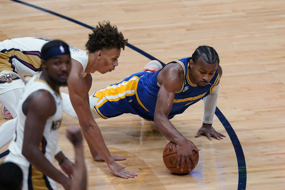 Golden State Warriors guard Ryan Rollins dives for the ball against New Orleans Pelicans guard Dyson Daniels in the second half of an NBA basketball game in New Orleans, Monday, Nov. 21, 2022. The Pelicans won 128-83. (AP Photo/Gerald Herbert)