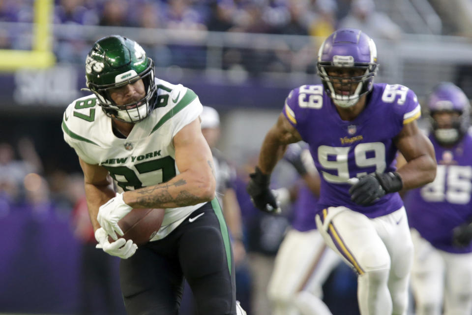 New York Jets tight end C.J. Uzomah (87) runs from Minnesota Vikings linebacker Danielle Hunter (99) after catching a pass during the second half of an NFL football game, Sunday, Dec. 4, 2022, in Minneapolis. (AP Photo/Andy Clayton-King)