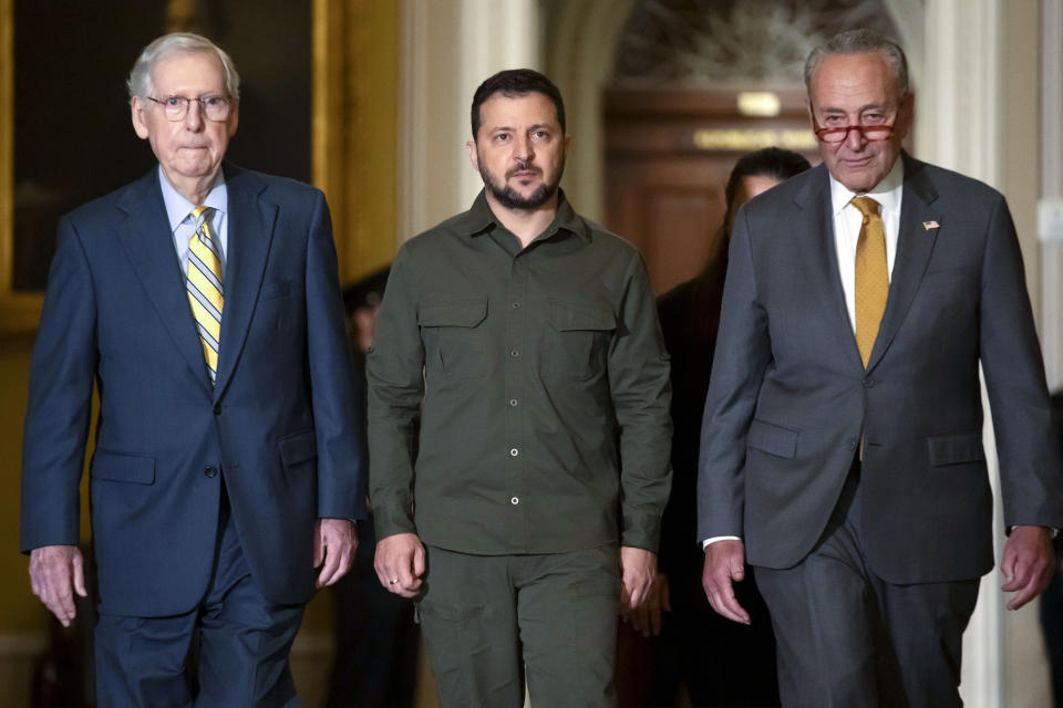 FILE - Ukrainian President Volodymyr Zelenskyy, center, walks with Senate Minority Leader Mitch McConnell of Ky., left, and Senate Majority Leader Chuck Schumer of N.Y., right, at Capitol Hill on Thursday, Sept. 21, 2023, in Washington. President Joe Biden’s nearly $106 billion aid package for Ukraine, Israel and other needs sits idle in Congress, neither approved nor rejected, but subjected to new political demands. Republicans are insisting on U.S.-Mexico border policy provisions in exchange for any new funds for Ukraine to fight Russia. (AP Photo/Mark Schiefelbein, File)