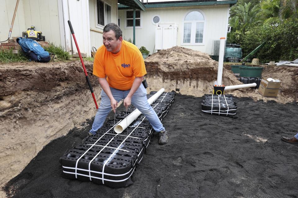 Jim King, CEO of Eljen Corporation, demonstrates how to install a septic tank and leach system to replace a cesspool at a home in Waialua, Hawaii on Thursday, May 11, 2023. Hawaii has 83,000 of cesspools, more than any other U.S. state, and many of them are close to the shoreline.(AP Photo/Marco Garcia)