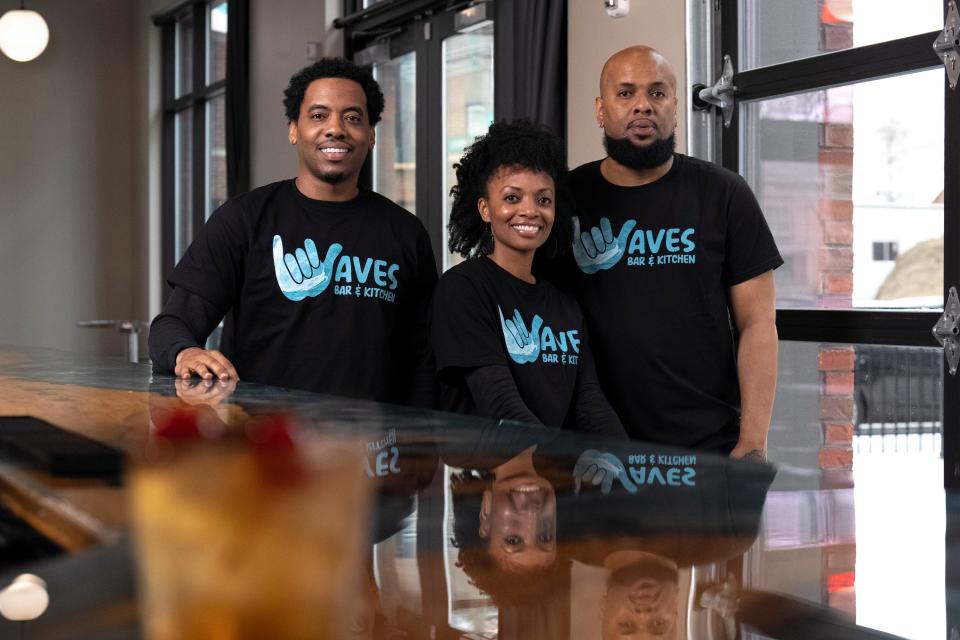 Left to right, siblings and owners of Waves Bar Timothy Brown, Tanitia Brown and David Burke stand for a portrait inside the bar located in the King-Lincoln Bronzeville neighborhood of Columbus on Jan. 6, 2023.