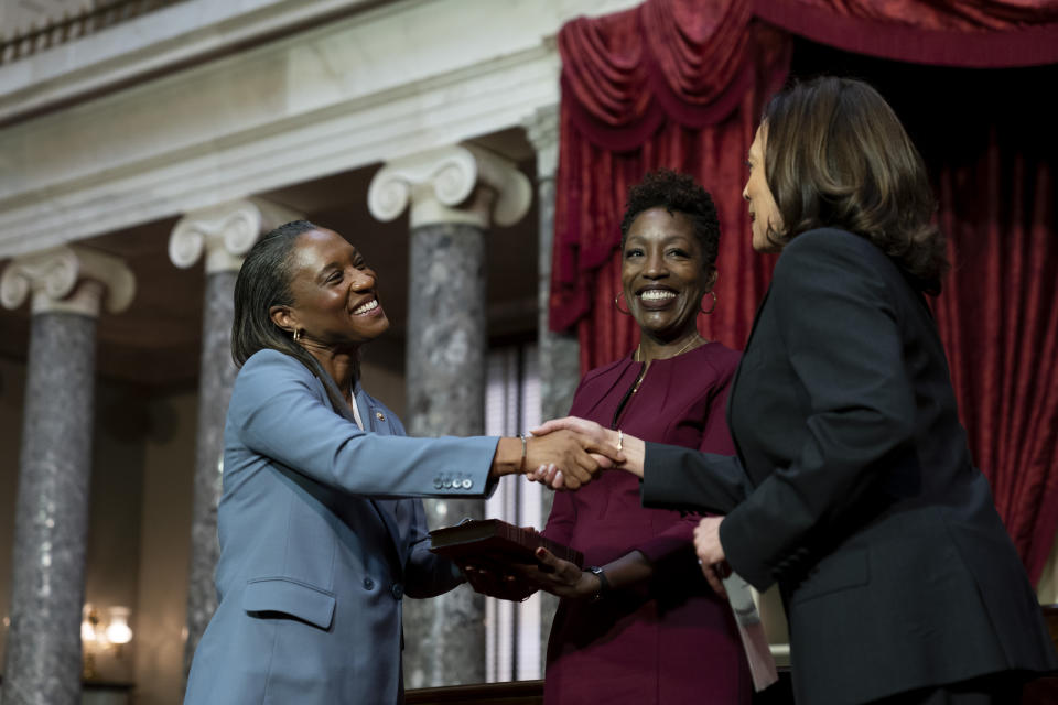 Vice President Kamala Harris, right, swears in Laphonza Butler, D-Calif., left, to the Senate to succeed the late Sen. Dianne Feinstein during a re-enactment of the swearing-in ceremony on Tuesday, Oct. 3, 2023, on Capitol Hill in Washington. Butler's wife, Neneki Lee, center, holds the Bible. (AP Photo/Stephanie Scarbrough)