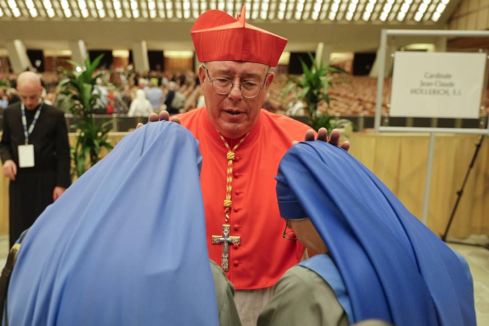 Cardinal Jean-Claude Hollerich greets two nuns prior to meeting relatives and friends after he was elevated to cardinal by Pope Francis, at the Vatican, Saturday, Oct. 5, 2019. Pope Francis has chosen 13 men he admires and whose sympathies align with his to become the Catholic Church's newest cardinals. (AP Photo/Andrew Medichini)