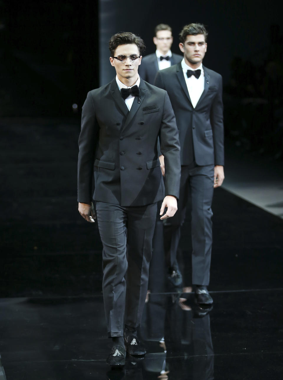 Models wear creations for Emporio Armani men's Fall-Winter 2014 collection, part of the Milan Fashion Week, unveiled in Milan, Italy, Monday, Jan. 13, 2014. (AP Photo/Antonio Calanni)