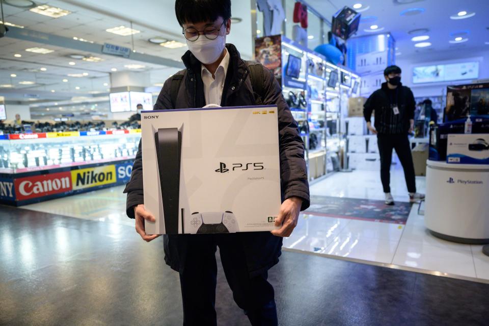 A customer takes home a new PlayStation 5 in Seoul On Nov. 12 after Sony launched the new console in select markets around the world.