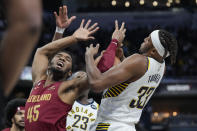 Cleveland Cavaliers guard Donovan Mitchell (45) gets the ball stripped away by Indiana Pacers center Myles Turner (33) during the first half of an NBA basketball game in Indianapolis, Sunday, Feb. 5, 2023. (AP Photo/AJ Mast)