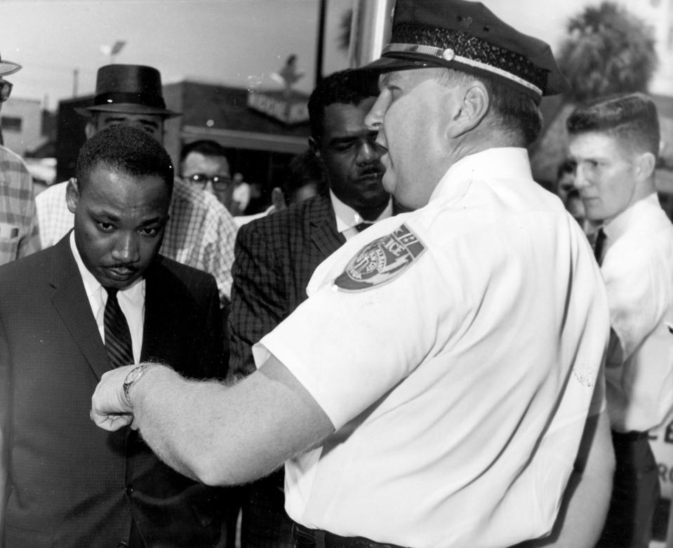 In this July 27, 1962 file photo, Martin Luther King, Jr., is arrested by Albany's Chief of Police Laurie Pritchett after praying at City Hall in Albany, Ga. King participated in a months-long campaign of local anti-segregation led by the Southern Christian Leadership Conference.