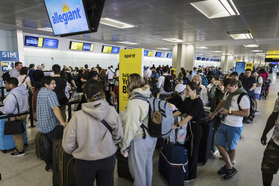 Travelers check in at the Spirit Airline ticket counters at Terminal B in Newark International Airport in Newark, N.J., Wednesday, June 28, 2023. Airline passengers face delays following flight cancellations due to storms in the region. (AP Photo/Stefan Jeremiah)
