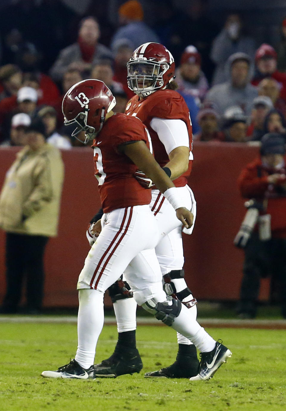 Alabama quarterback Tua Tagovailoa (13) is helped off the field by offensive lineman Jedrick Wills Jr. (74) during the second half of an NCAA college football game against Mississippi State, Saturday, Nov. 10, 2018, in Tuscaloosa, Ala. (AP Photo/Butch Dill)