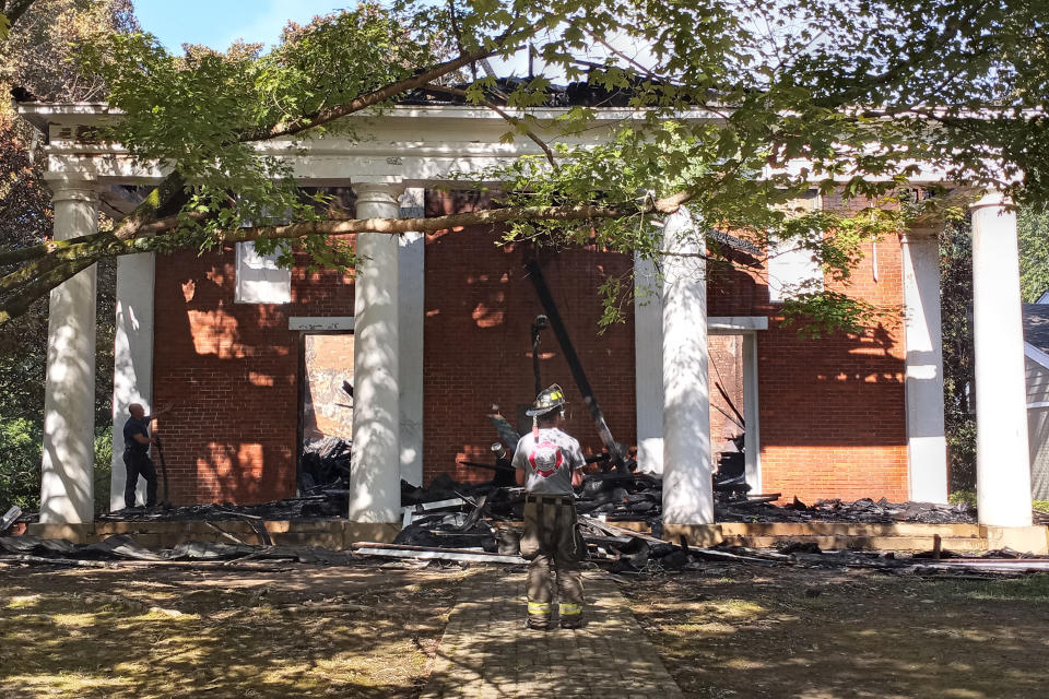 A Lafayette County firefighter inspects the College Hill Presbyterian Church, near Oxford, Miss., Sunday morning, Aug. 14, 2022, after a Saturday night fire destroyed the majority of the historical structure. The church which was built in 1844, is where William Faulkner and his wife, Estelle, were married in 1929 — two decades before the novelist received the Nobel Prize in literature. (Maya Martin/The Oxford Eagle, via AP)