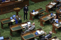 Assemblyman Ian Calderon, D-Whittier, top center, presents a measure before the Assembly at the Capitol in Sacramento, Calif., Monday, June 8, 2020. The Assembly held its first full session, Monday, since going into a recess in March due to the coronavirus pandemic. Lawmakers practiced social distancing by having only one person per pair of desks and other legislators moved to different areas of the chambers.(AP Photo/Rich Pedroncelli)