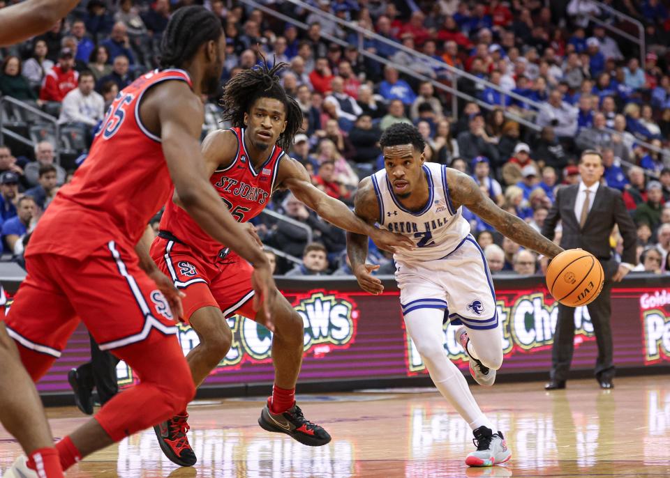 Jan 16, 2024; Newark, New Jersey, USA; Seton Hall Pirates guard Al-Amir Dawes (2) dribbles as St. John's Red Storm forward Glenn Taylor Jr. (35) and forward Drissa Traore (55) defend during the second half at Prudential Center. Mandatory Credit: Vincent Carchietta-USA TODAY Sports