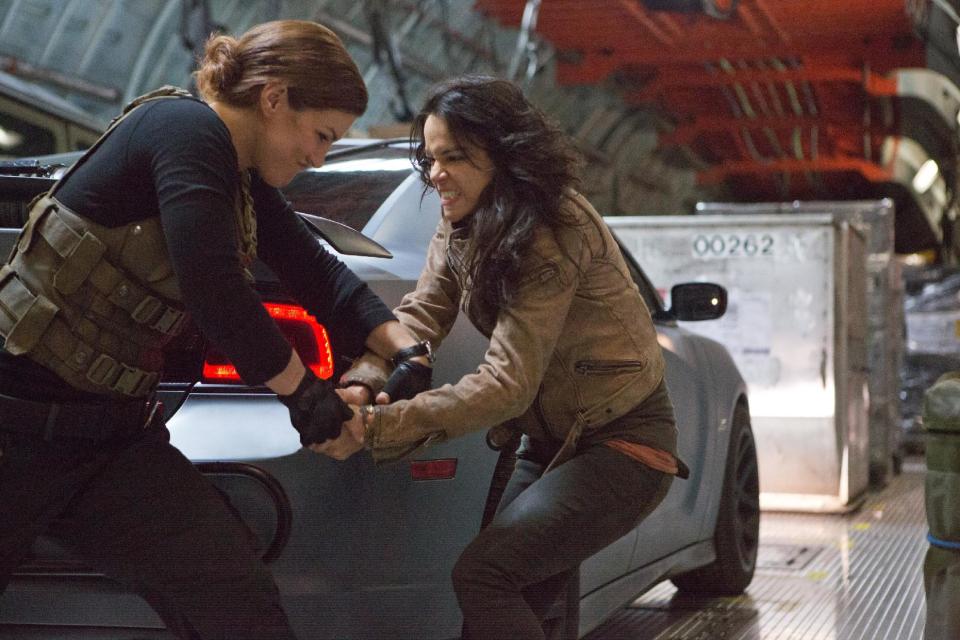 This film publicity image released by Universal Pictures shows Gina Carano, left, and Michelle Rodriguez in a scene from "Fast & Furious 6." (AP Photo/Universal Pictures, Giles Keyte)