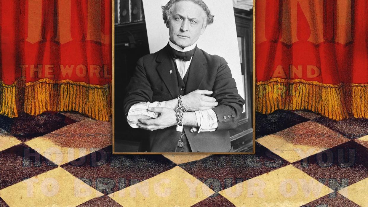 harry houdini with locked chains around wrists