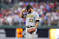 Pittsburgh Pirates pitcher Bryse Wilson adjusts his hat after giving up a run-scoring single to Philadelphia Phillies' Nick Castellanos during the first inning of a baseball game, Friday, Aug. 26, 2022, in Philadelphia. (AP Photo/Matt Slocum)