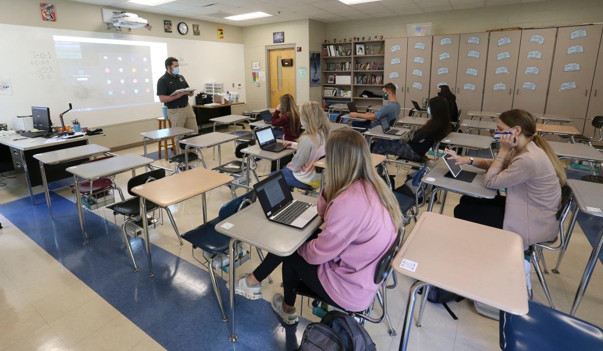 Northridge High Advanced Placement English instructor Clancy Bryant teaches his in-person learners and his remote learners whose icons are projected on the board behind him Oct. 13, 2020. [Staff Photo/Gary Cosby Jr.]